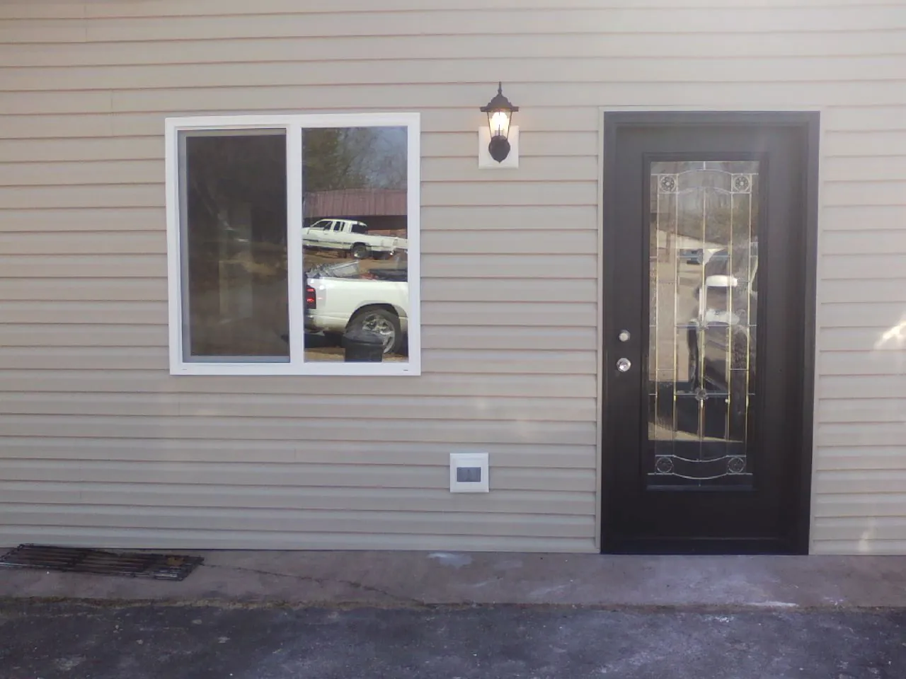 New siding, window and entry door on the side of an addition in Ashburn